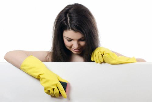 Domestic cleaner in E9 tidying a family kitchen and living area